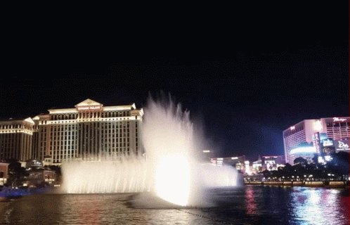 A Fountain In Front Of A Building That Says ' Bellagio ' On It GIF