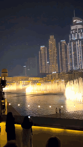 A Fountain In Front Of A Building That Says Dubai On It GIF