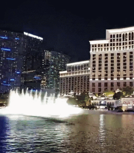 A Fountain In Front Of A Large Building That Says The Cosmopolitan GIF