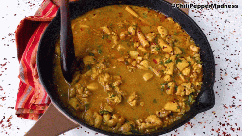 A Frying Pan Filled With Chicken Curry With The Hashtag Chili Pepper Madness On The Bottom GIF