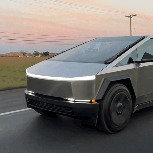 A Futuristic Car Is Driving Down A Road GIF