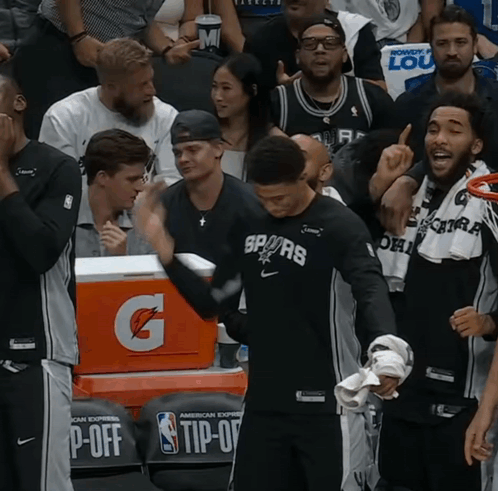 A Gatorade Cooler Sits Behind A Group Of Basketball Players GIF