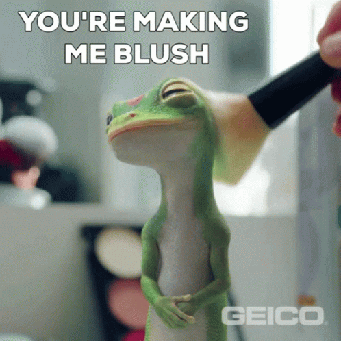 A Geico Lizard Is Being Brushed With A Brush GIF