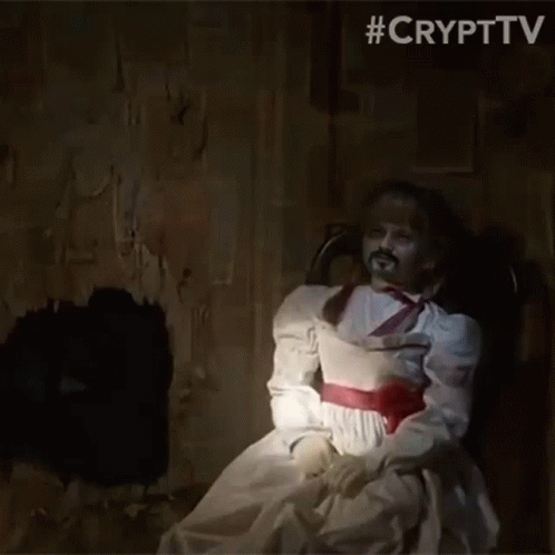 A Ghost Doll Is Sitting In A Chair In A Dark Room . GIF