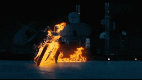 A Ghost Rider Is Riding A Motorcycle Through The Air With Flames Coming Out Of It . GIF