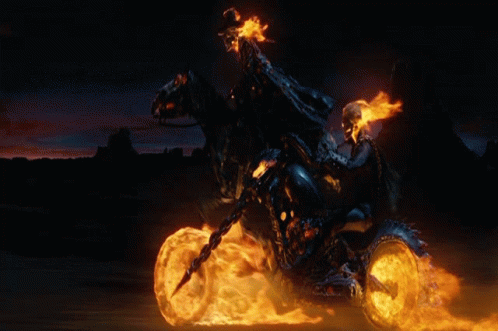 A Ghost Rider Is Riding A Motorcycle With Flames Coming Out Of The Wheels GIF