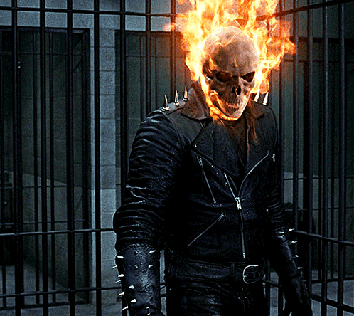 A Ghost Rider With Flames Coming Out Of His Head Stands In Front Of A Prison Cell GIF