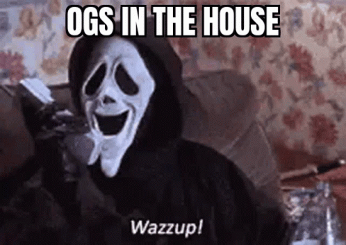 A Ghostface From The Movie Scream Is Sitting On A Couch Holding A Remote Control . GIF