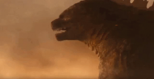 A Giant Monster Is Standing In The Middle Of A Field . GIF