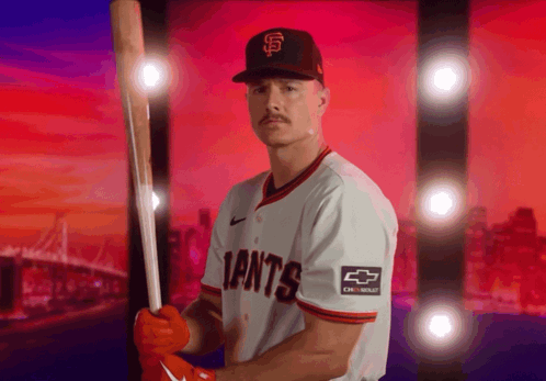 A Giants Baseball Player Is Holding A Bat GIF