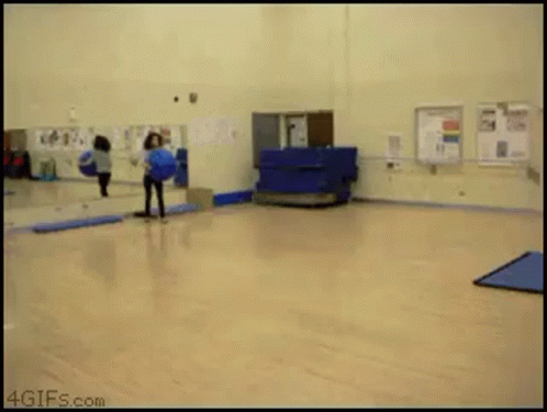 a gif from 4gifs.com shows a person doing a trick on a ball