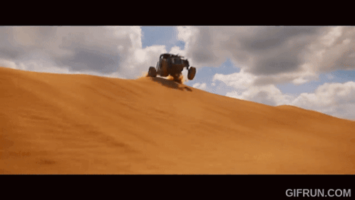 A Gif From Gifrun.com Shows A Vehicle Driving Down A Sandy Hill GIF