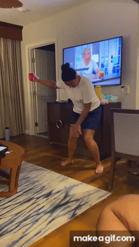 A Gif Of A Woman Dancing In Front Of A Tv With The Words Make A Gif.com At The Bottom GIF