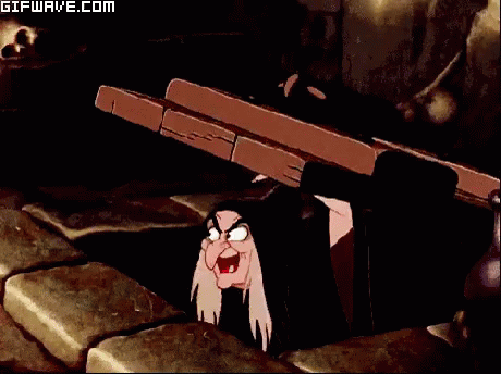 A Gifwave.com Animated Image Of A Witch Peeking Out From Under A Table GIF