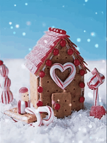A Gingerbread House Decorated With Candy Canes And A Heart Shaped Door GIF