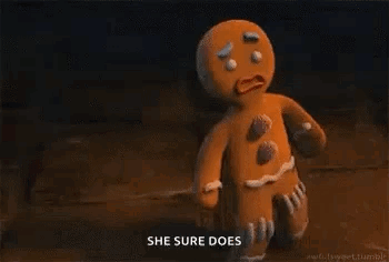 A Gingerbread Man From Shrek Is Holding A Stick In His Hand And Says `` She Sure Does '' . GIF