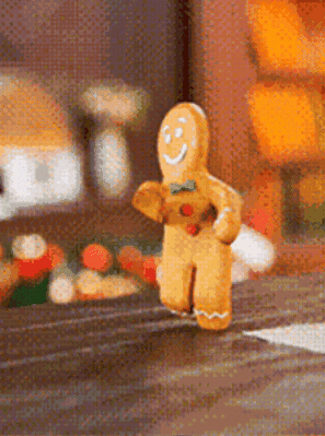 A Gingerbread Man Is Running Down A Street GIF