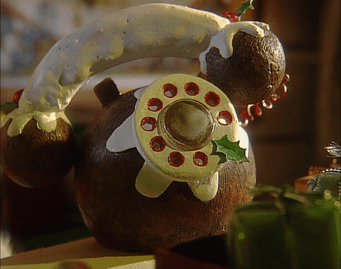 A Gingerbread Telephone With Icing On It GIF