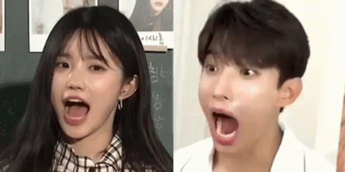 A Girl And A Boy Are Making Funny Faces With Their Mouths Wide Open . GIF