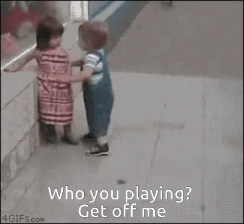 a girl and a boy are playing with a basketball and the girl asks the boy to get off her