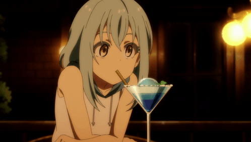 A Girl Drinking From A Martini Glass With A Blue Liquid In It GIF