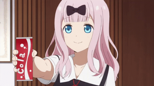 A Girl Holding A Can Of Cola In Her Hand GIF