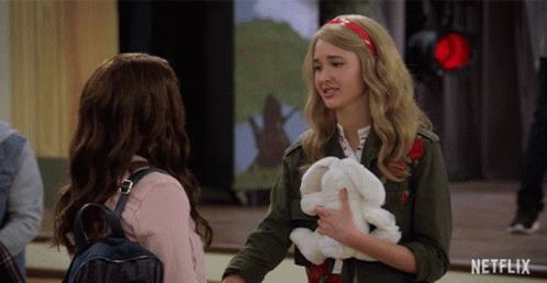 Girl Holding Stuffed Rabbit Talking To Another Girl GIF