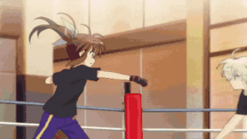 A Girl In A Black Shirt And Blue Pants Is Standing In A Boxing Ring GIF