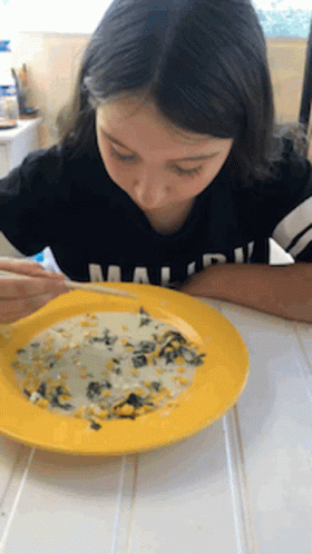 A Girl In A Black Shirt With The Word Malibu On It GIF