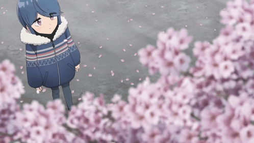 A Girl In A Blue And White Striped Jacket Stands In Front Of A Tree With Pink Flowers GIF