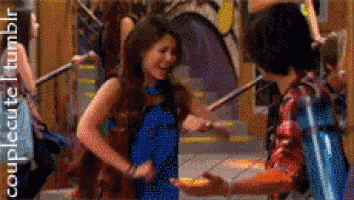 A Girl In A Blue Dress Is Dancing With A Boy In A Red Plaid Shirt GIF
