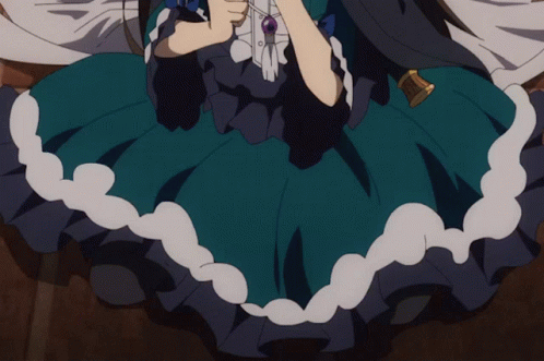 A Girl In A Blue Dress Is Holding A Necklace GIF