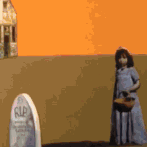a girl in a blue dress is standing in front of a gravestone that says rip