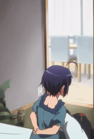 A Girl In A Blue Dress Stands In Front Of A Window GIF