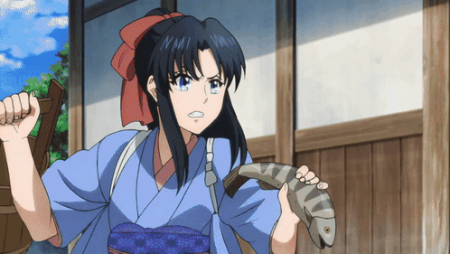A Girl In A Blue Kimono Is Holding A Fish In Her Hands GIF