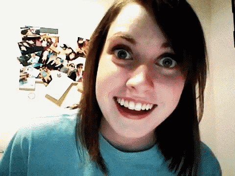 A Girl In A Blue Shirt Is Smiling With Her Mouth Wide Open GIF