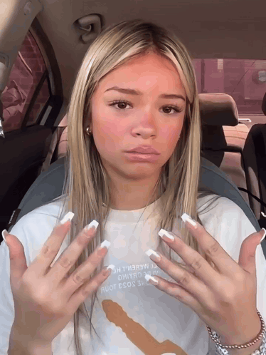 A Girl In A Car With A T-Shirt That Says " I Love You " GIF