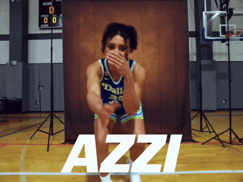 A Girl In A Dallas Jersey Is Kneeling On A Basketball Court GIF