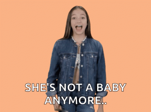 A Girl In A Denim Jacket Giving A Thumbs Down Sign With The Words She 'S Not A Baby Anymore GIF