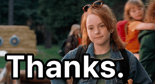 A Girl In A Denim Jacket Is Standing In Front Of A Sign That Says " Thanks " GIF