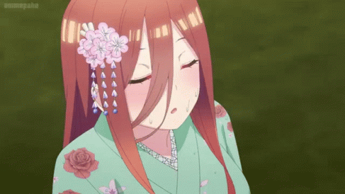 A Girl In A Green Kimono With Flowers In Her Hair GIF