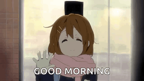 A Girl In A Hat And Scarf Is Waving At The Camera . GIF