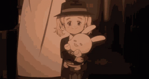 A Girl In A Hat Is Holding A Stuffed Animal GIF