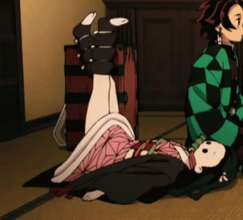 A Girl In A Kimono Is Laying On The Floor Next To A Man GIF