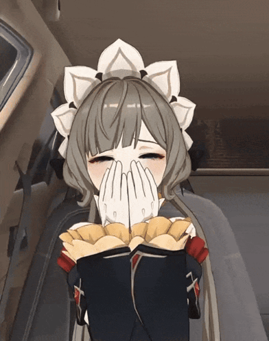 a girl in a maid outfit is covering her face with her hands while holding a bag of chips
