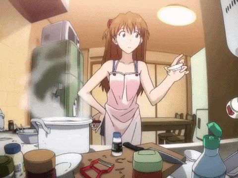 Girl In Pink Apron Standing In Kitchen GIF