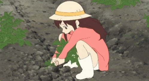 A Girl In A Pink Dress And White Boots Is Kneeling Down Picking Leaves GIF