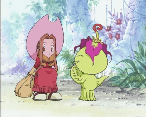 A Girl In A Pink Hat Is Sitting Next To A Green Monster GIF