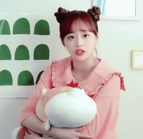 A Girl In A Pink Shirt Is Holding A Stuffed Animal In Her Arms And The Word Chuling Is Above Her GIF