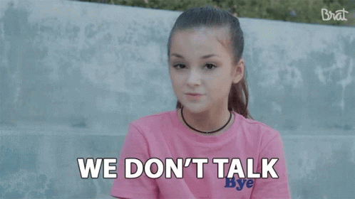 A Girl In A Pink Shirt Is Saying `` We Make Money Moves '' While Sitting On A Bench . GIF